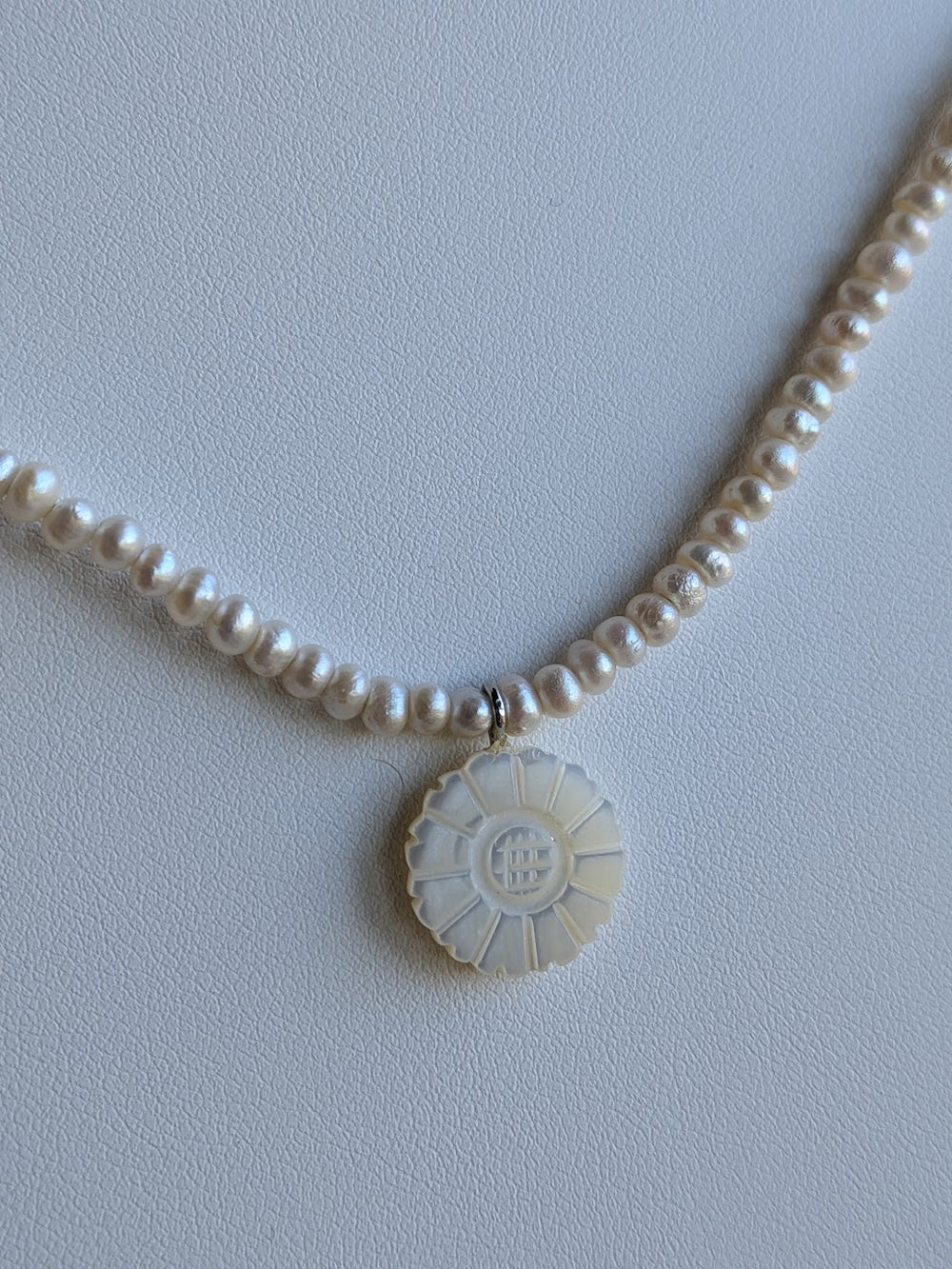 Genuine freshwater pearl strand with hand carved mother-of-pearl flower charm by Sunny Z Jewelry
